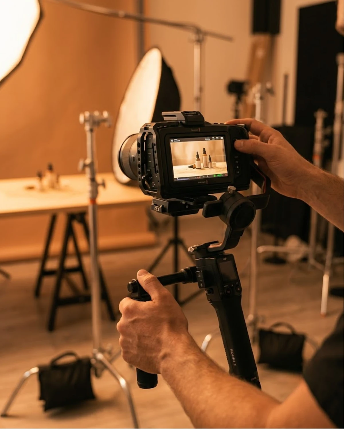 Videographer operating a cinema camera on a gimbal during a product shoot